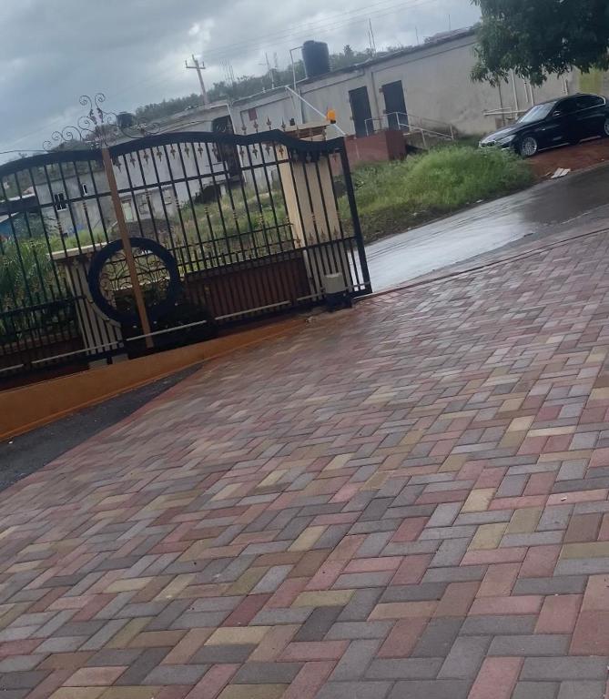 a black wrought iron fence on a brick sidewalk at DaRoyals in Junction
