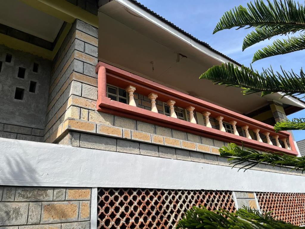 a balcony on the side of a building at Golf B&B in Nyahururu