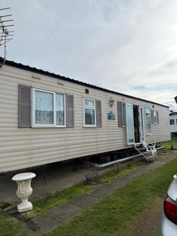 a house that is sitting in the grass at seton sands caravan in Port Seton