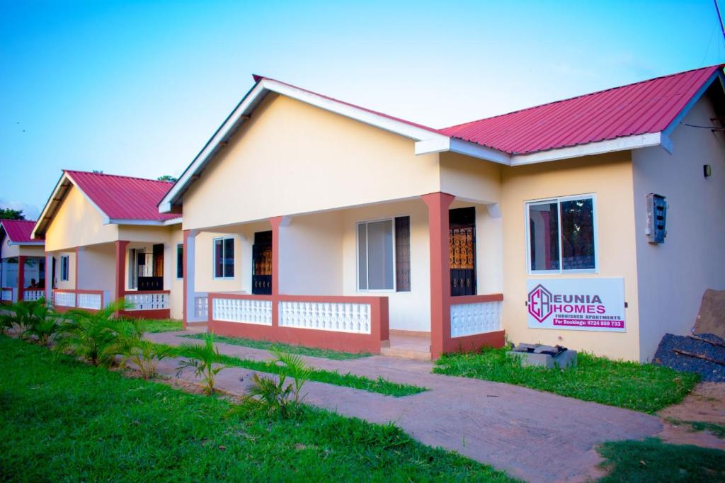 a house with a red roof at Eunia homes in Kibarani