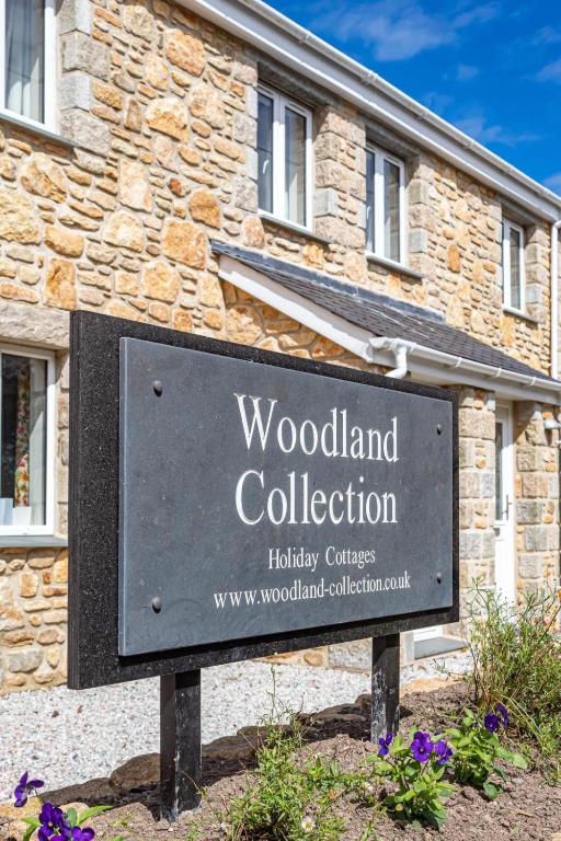 a sign in front of a building at The Woodland Collection, 10 mins from beaches in Hayle