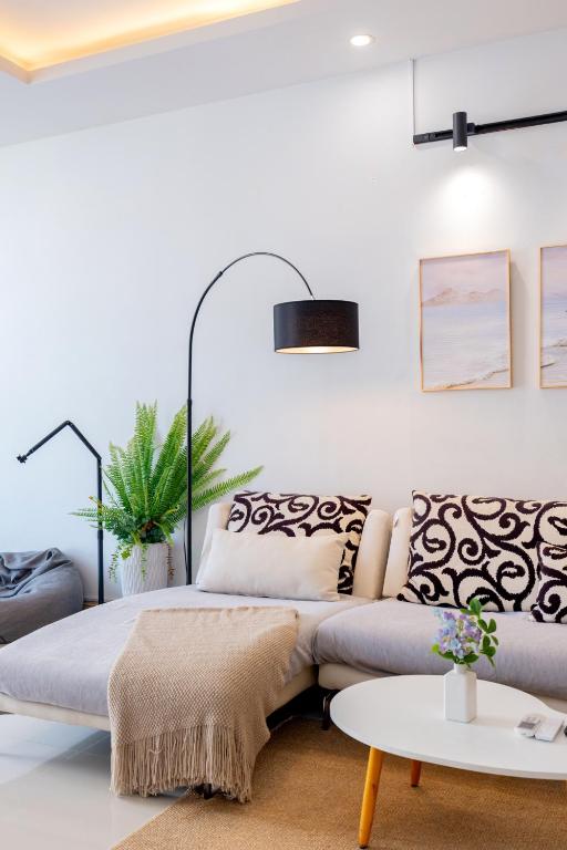 a living room with a couch and a table at Kozy Home Apartment in Vung Tau - Tam Thang Tower View & Back Beach step away in Vung Tau