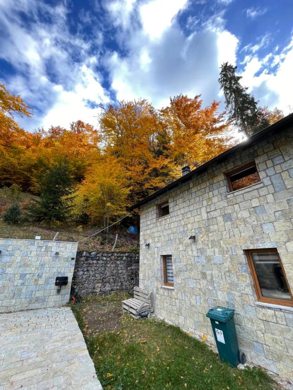 a stone building with a trash can next to it at Villa Fresku in Peje