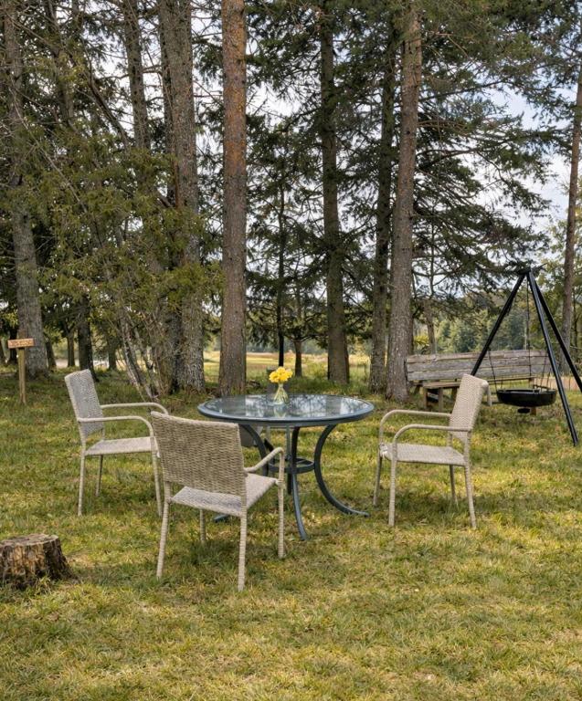 a table and chairs and a swing in a yard at Kyrkåsen in Borgvik