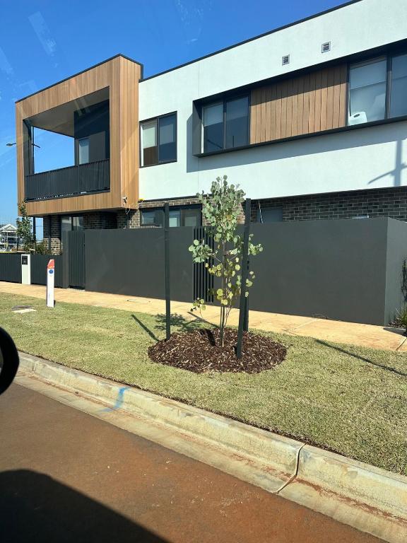 a building with a tree in front of it at The elite Home in Rockbank