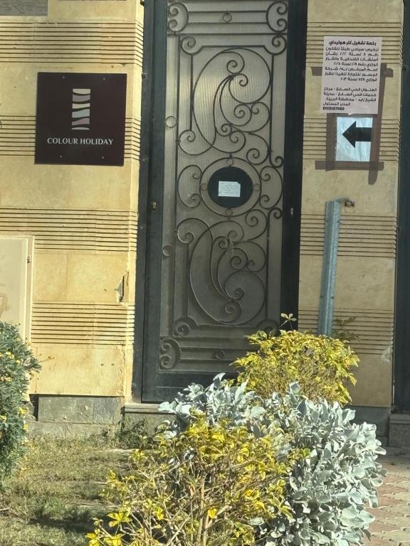a door on the side of a building with flowers at Zayed hotel in Sheikh Zayed