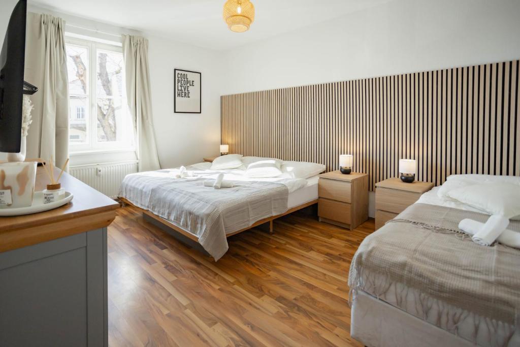 a hotel room with two beds and a window at Central Station Apartment in Dessau