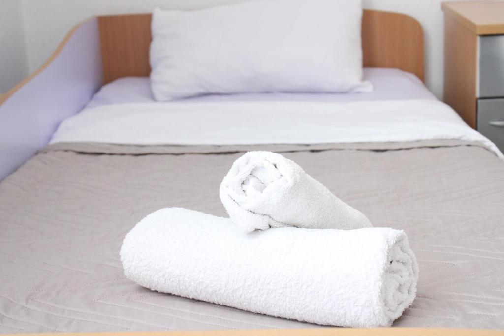 a pair of towels sitting on a bed at House Stoevi in Negotino