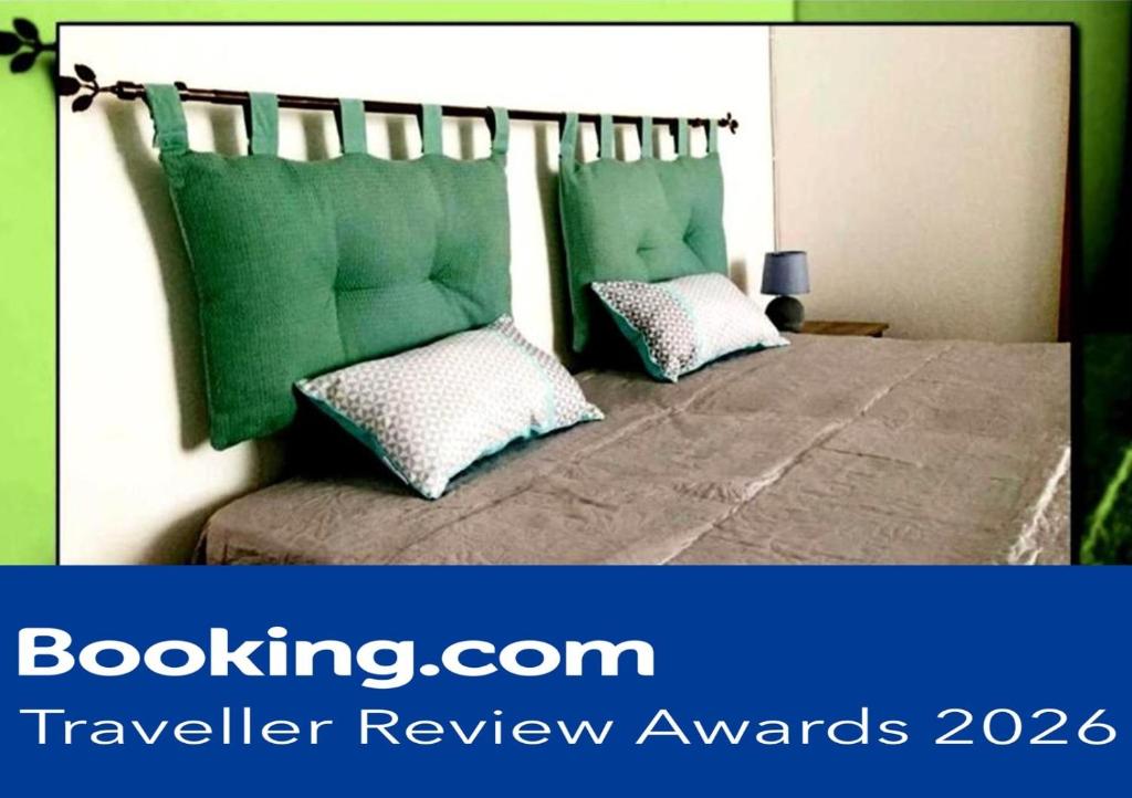 a bedroom with a bed with two green pillows at Casa Vacanze VALEDORA in Ponza