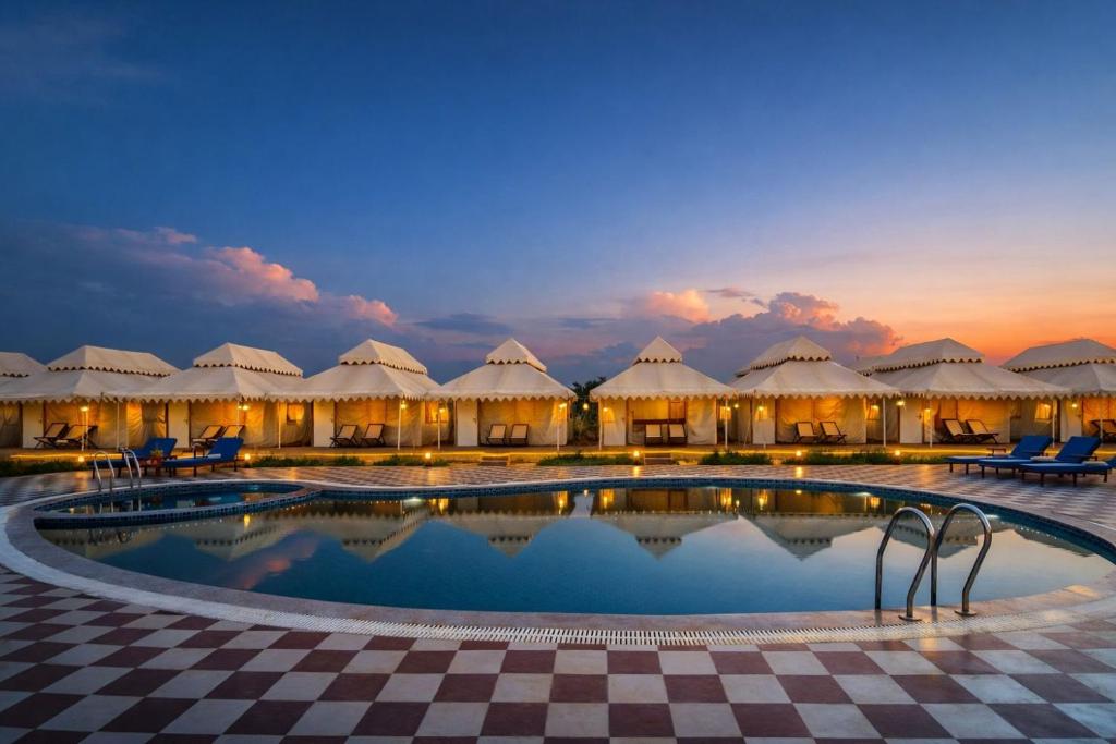 a view of a resort with a pool and chairs at Limra Desert Camp With Swimming pool in Jaisalmer
