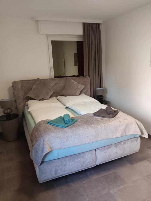 a bed with sandals and towels on top of it at Kontinental A in Bad Harzburg
