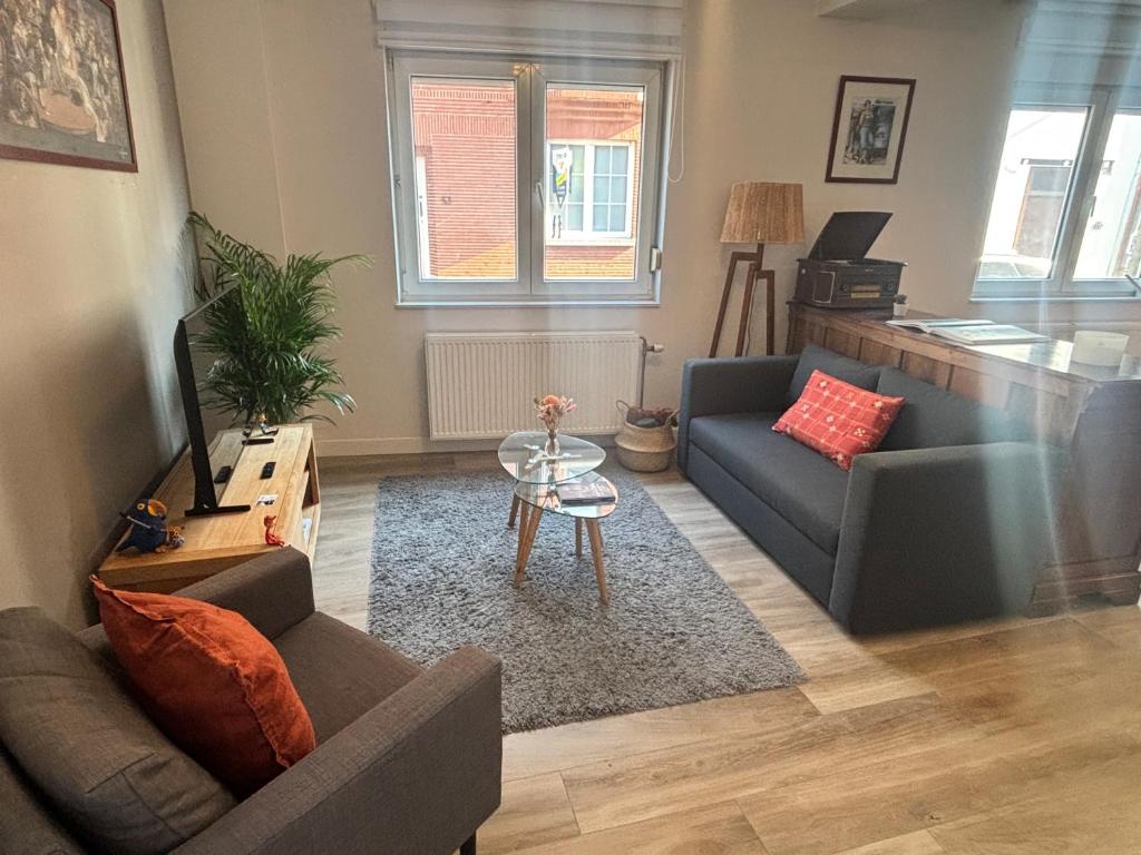 a living room with a couch and a table at Bel apartment - Waterloo in Waterloo
