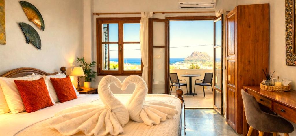 a bedroom with a bed with two swans on it at Knossos Skynest in Palekastron
