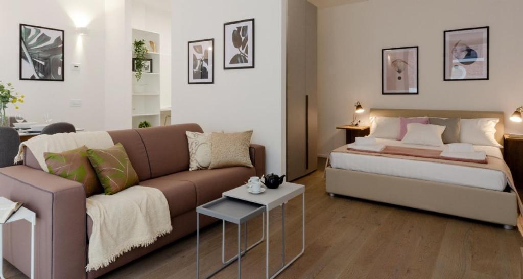 a living room with a couch and a bed at Modern Apartment between Como & Milan in Lomazzo