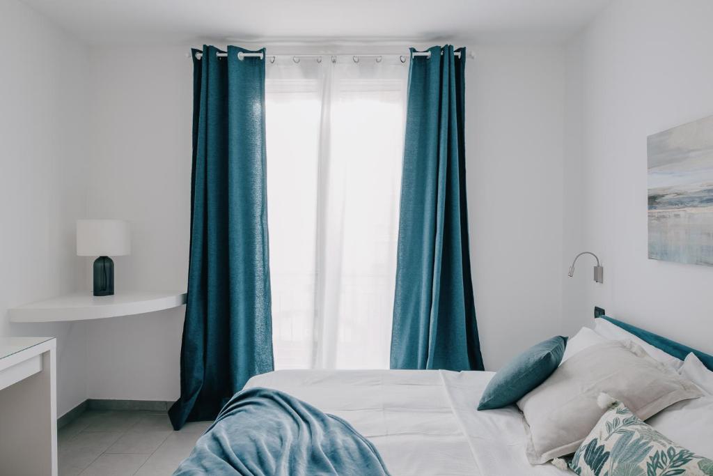 a bedroom with a bed with green curtains and a window at Domus Silvana Apartments in Ravenna