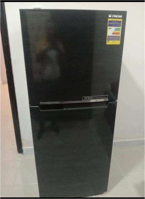 a black refrigerator with a sticker on the front of it at الغردقة - اول ممشى شيرى in Hurghada