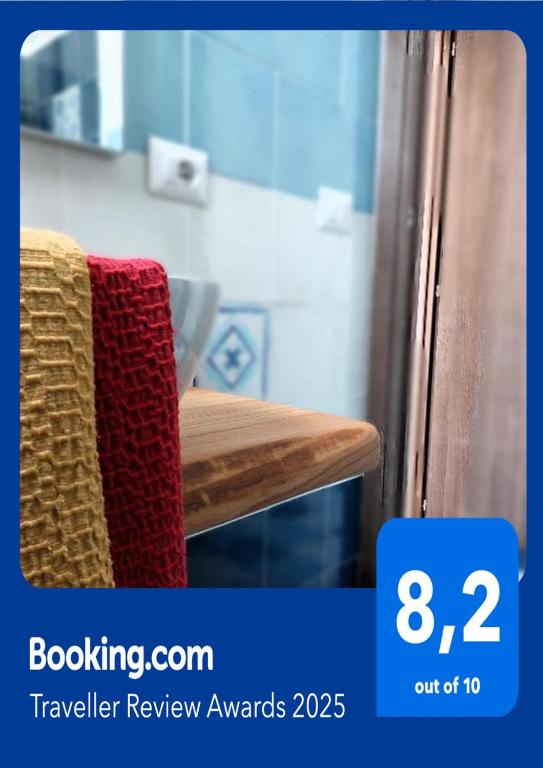 a red towel sitting on top of a wooden bench at La casa dei 4 venti Affittacamere in Ponza