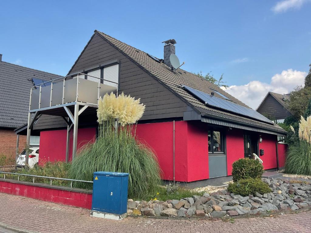 a red house with a black roof at Emma in Oberhausen