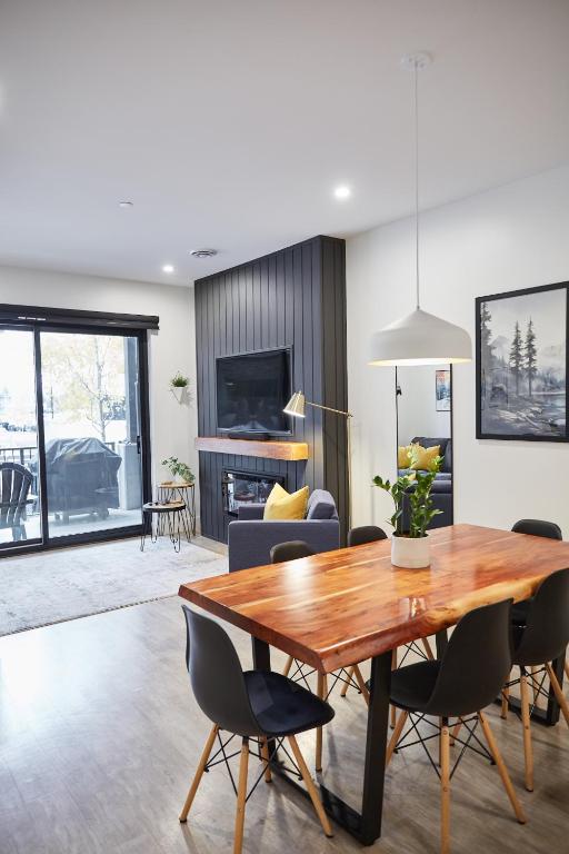a dining room with a wooden table and chairs at Ripper Retreat in Revelstoke