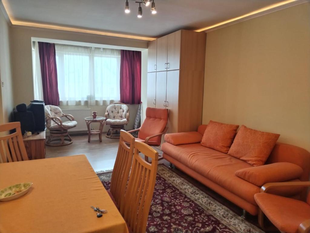 a living room with a couch and a table at Nelly Apartman in Gheorgheni
