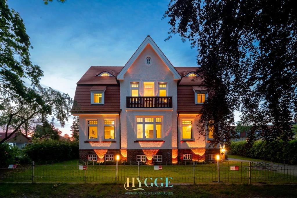 a large house with its lights on at Villa Hygge Kappeln - Design Ferienwohnungen in Kappeln