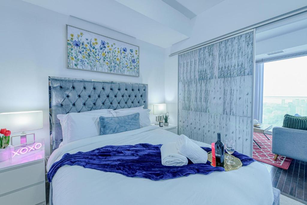 a bedroom with a large bed and a window at The York Suites in Toronto