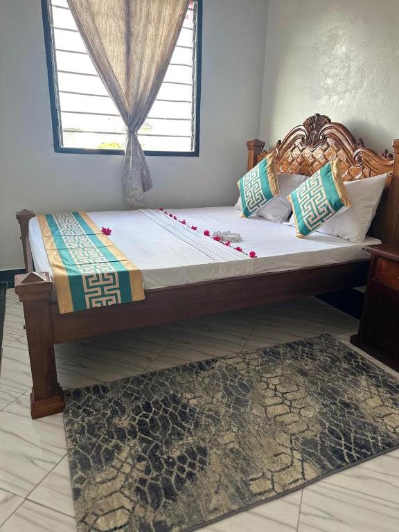 a large bed in a room with a window at Munaa House Wiyoni in Lamu