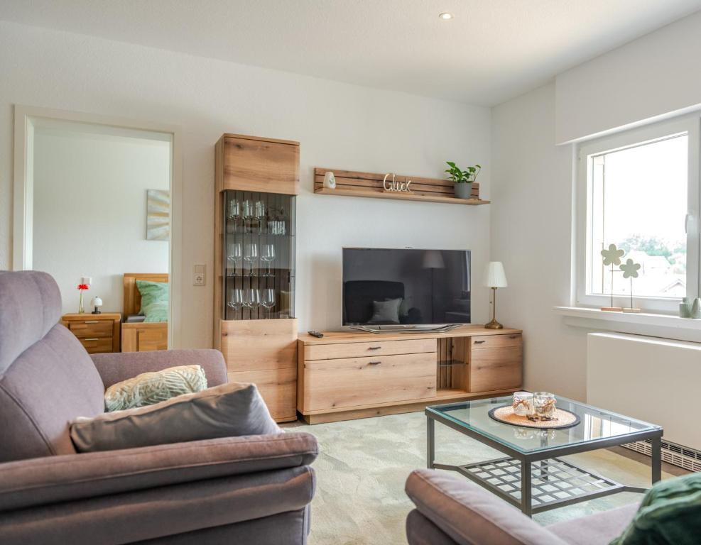 a living room with a couch and a tv at Ferienwohnung Anna in Heimbach