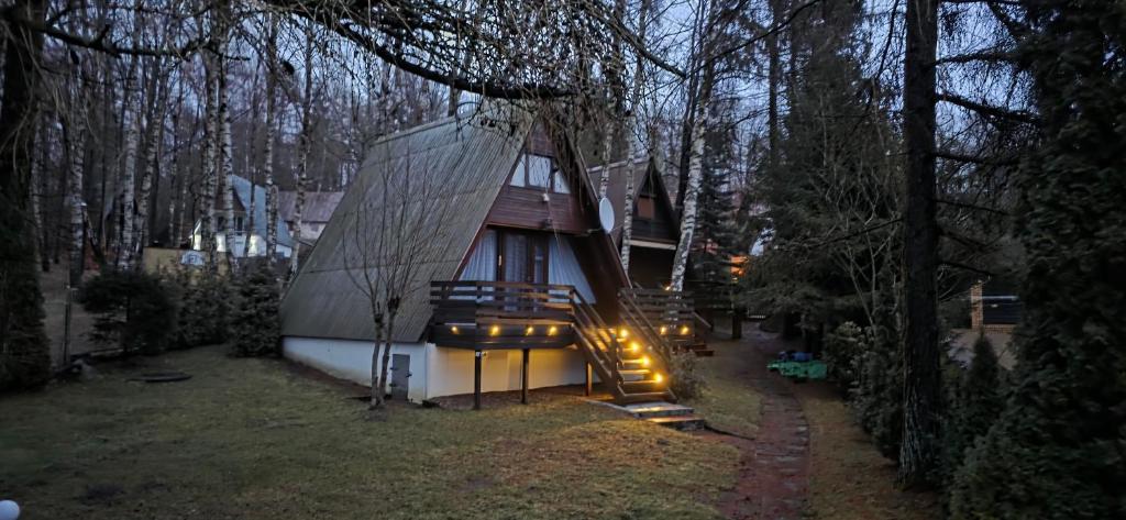 a house with a staircase leading up to it at Cabana Ińsko-domek 20 metrów od plaży in Ińsko