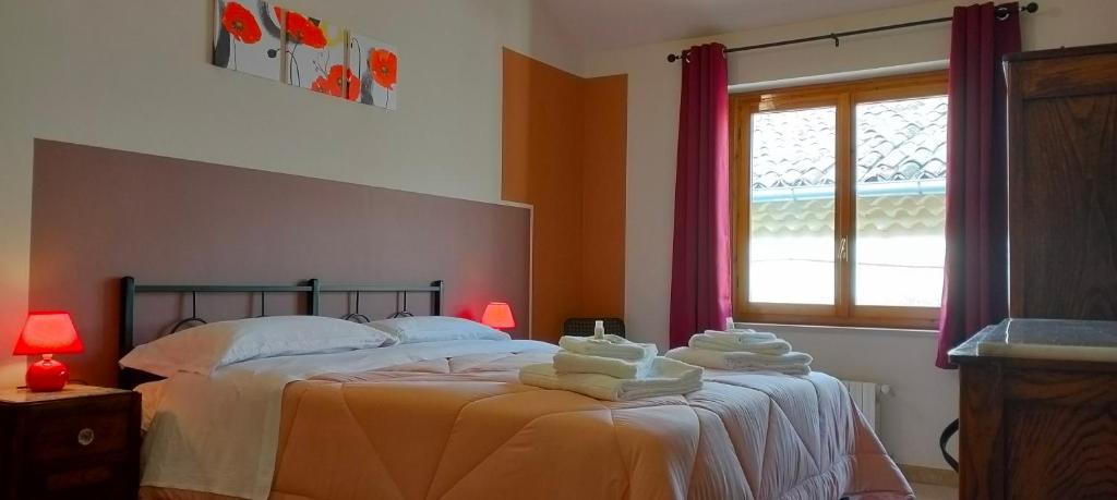 a bedroom with a bed with towels on it at Affittacamere San Nicola in Montella