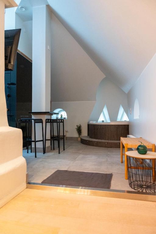 a living room with a table and chairs at Glorious penthouse with private sauna and jacuzzi in Helsinki