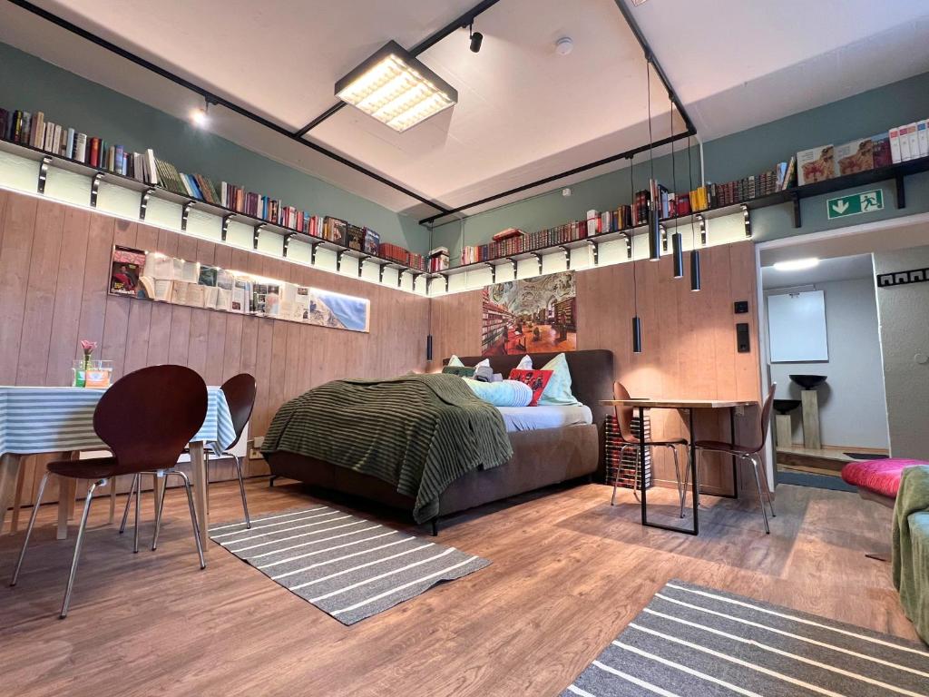 a bedroom with a bed and a table and chairs at Mitten im Zentrum Ferienwohnungen mit sonniger Terrasse in Telfs