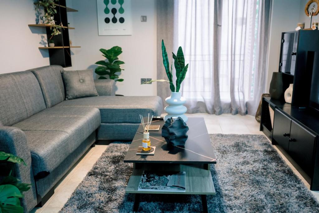 a living room with a couch and a table at Blue Horizon Corinth in Korinthos