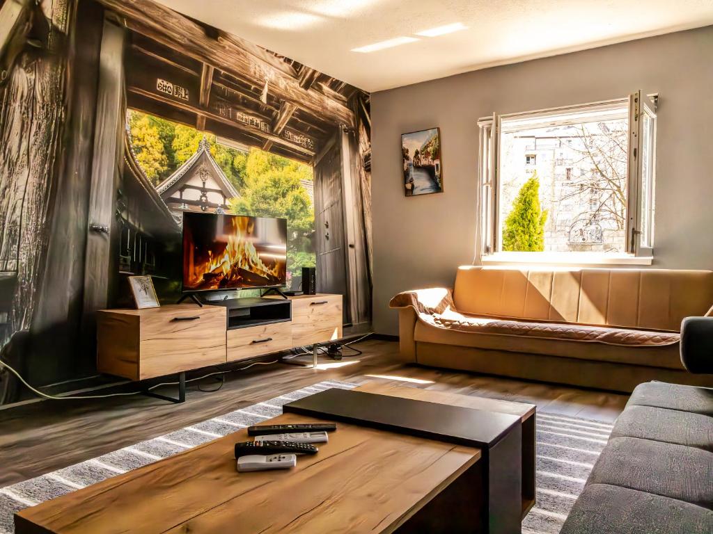 a living room with a couch and a tv at Villa Mia in Sarajevo
