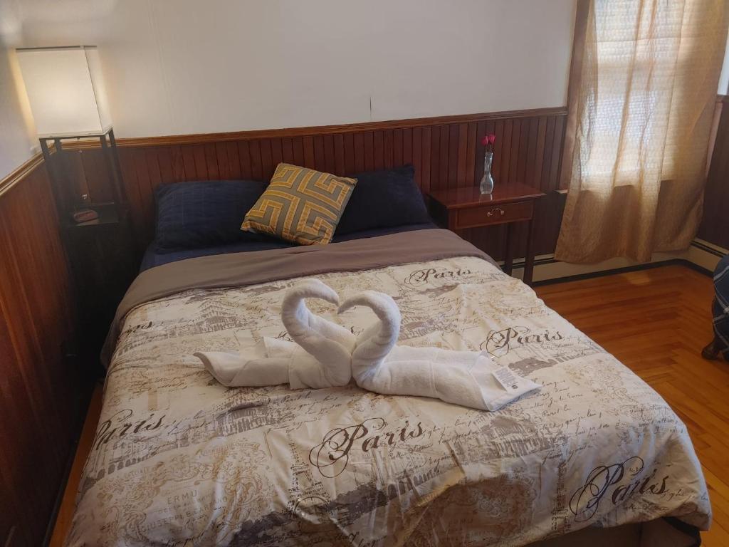 two swans made out of towels on a bed at Nigam's Sweet Home in Saint John