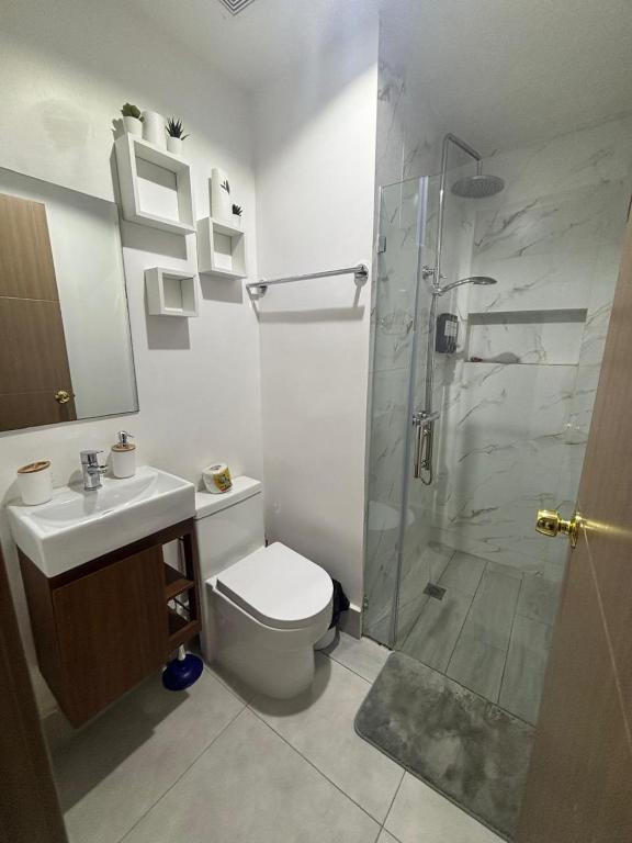 a bathroom with a shower and a toilet and a sink at The Perfect Place to be in Boca Chica