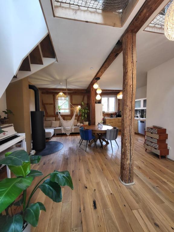 a living room with a wooden floor and a table at Kleine Oase in Ettenheim