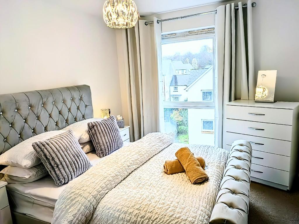 a bedroom with a bed and a window at Neptune 27 in Swansea