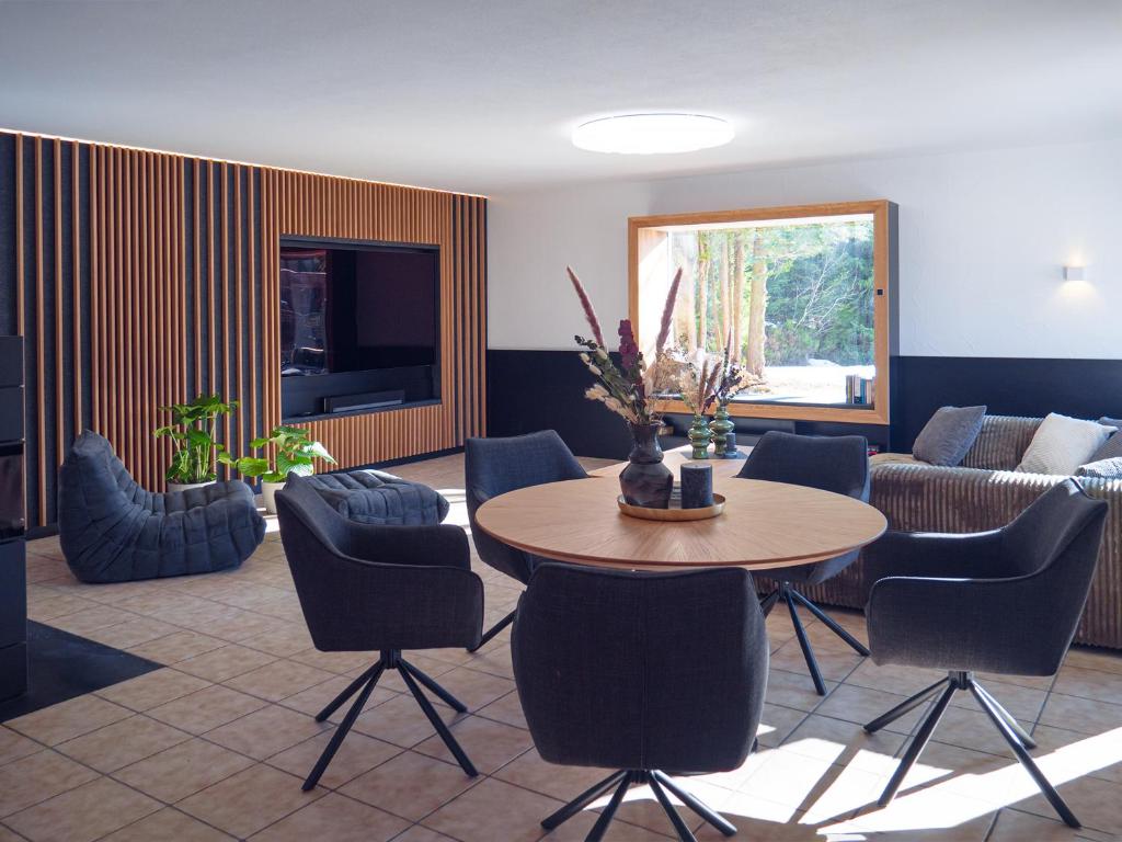 a living room with a table and chairs and a couch at Ferienhaus 76 in Freudenstadt
