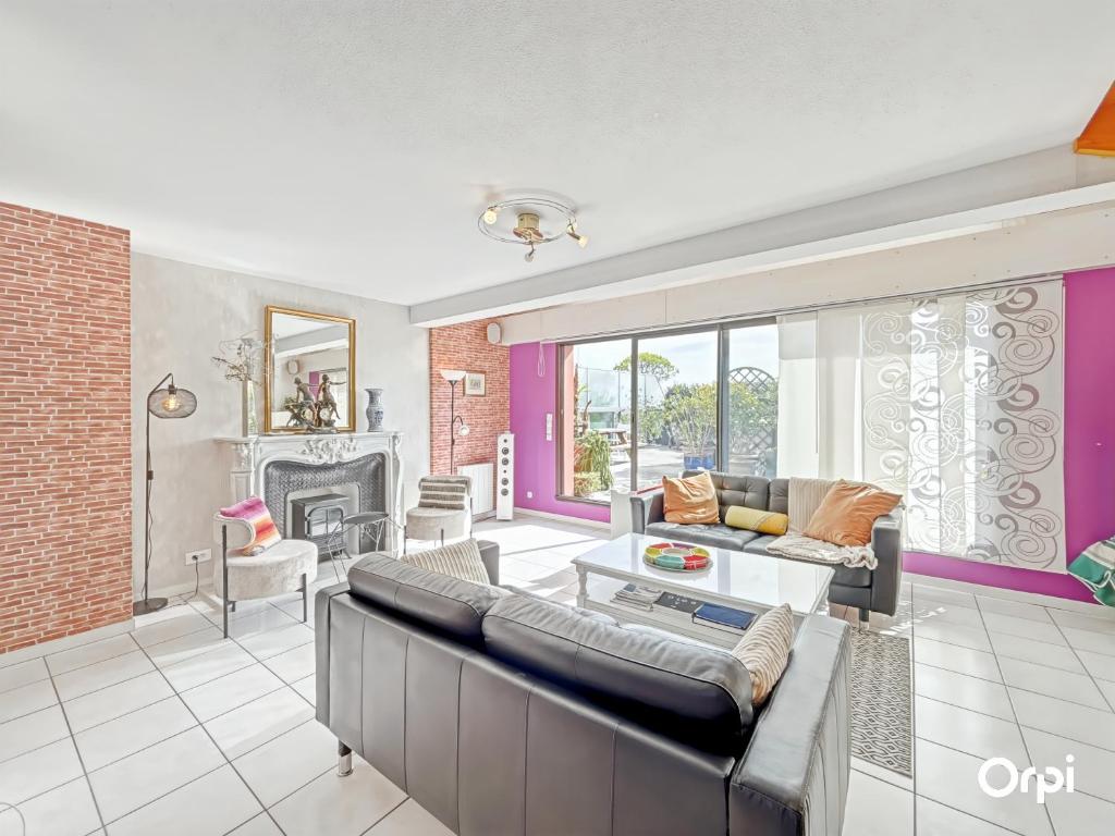 a living room with a couch and a fireplace at RÉF 353 appartement duplex Lorient centre in Lorient