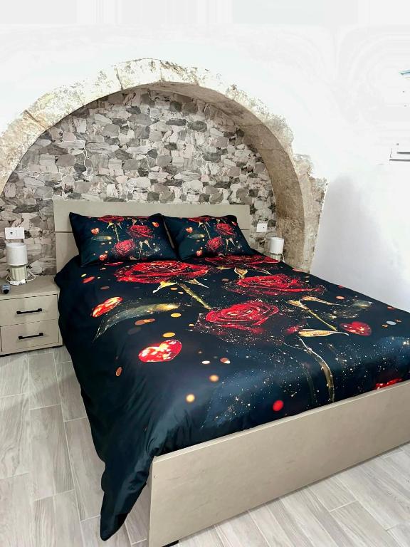 a bed in a bedroom with a stone wall at Residenza Ohana in Isernia