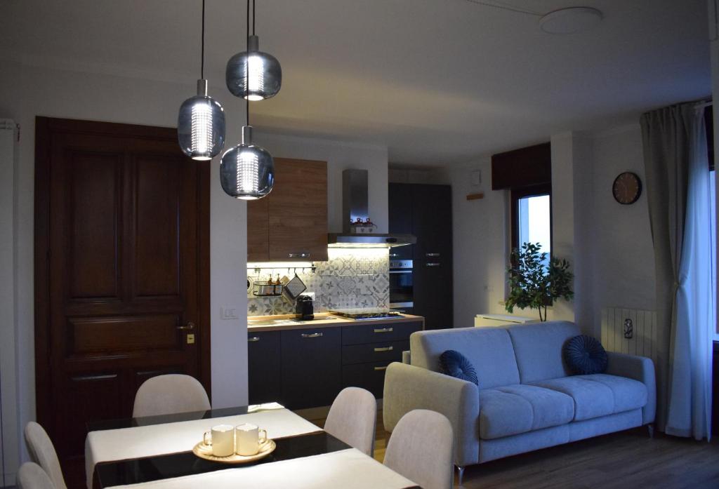 a living room with a blue couch and a table at EOS Suite Apartment - a due passi da Piazza Pisanelli e Ospedale Panico in Tricase