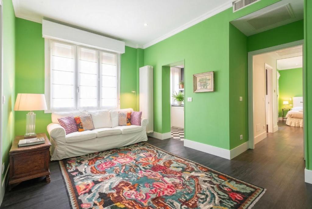 a living room with green walls and a white couch at Green House Historic Centre in Bologna