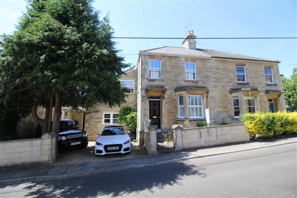 a white car parked in front of a brick house at Rockleigh House in Corsham