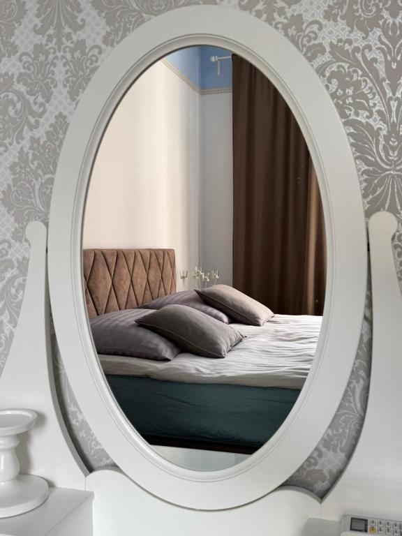 a bedroom with a bed in a mirror at Apartment with spacious terrace Villa Floramy in Opatija