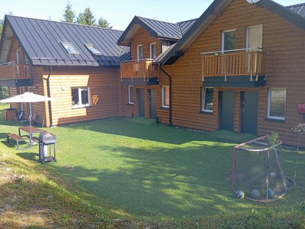 a house with a yard with a swing at Apartamenty u Jakubika in Krynica Zdrój