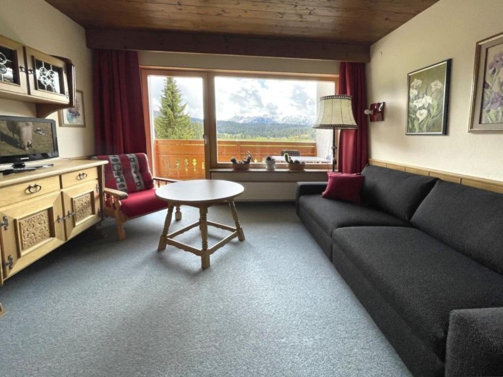 a living room with a couch and a table at Chalet Cristall Superior Appartement 9 in Leutasch