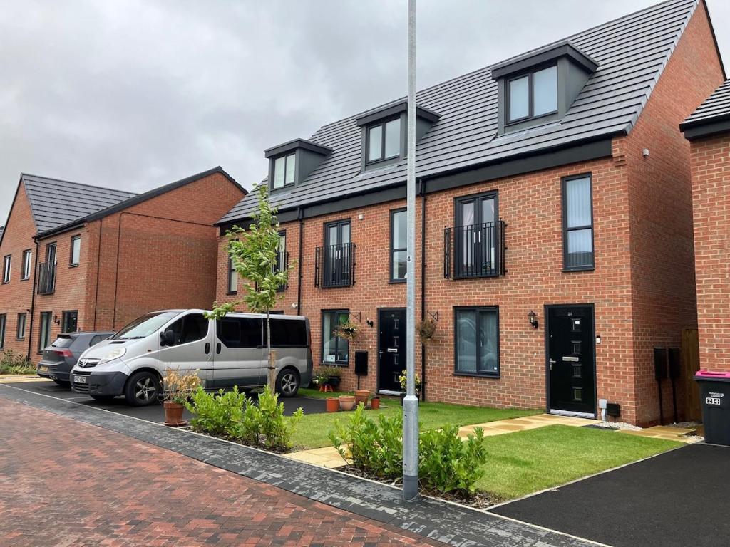 a house with cars parked in front of it at Waverley 3-Bed Springfields House in Rotherham