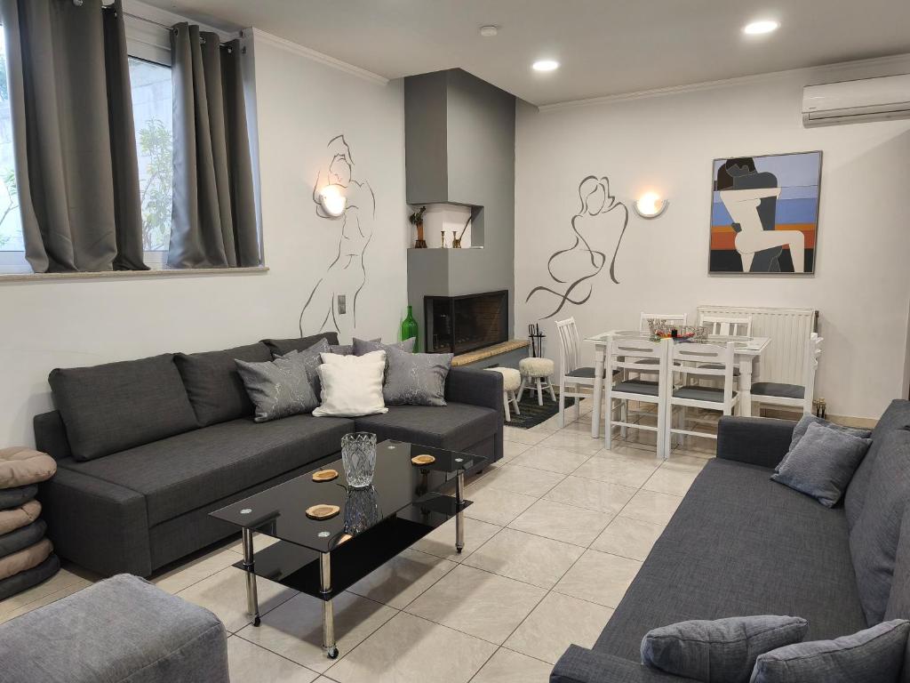 a living room with a couch and a table at Art house M & F in Órion