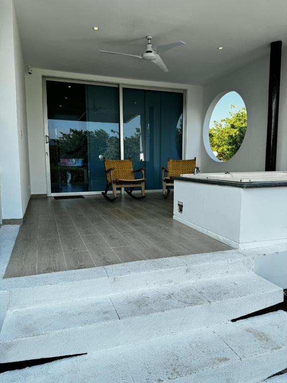 a patio with two chairs and a table at 31 Exclusive Cabin with Private Jacuzzi, Beach in Tubará